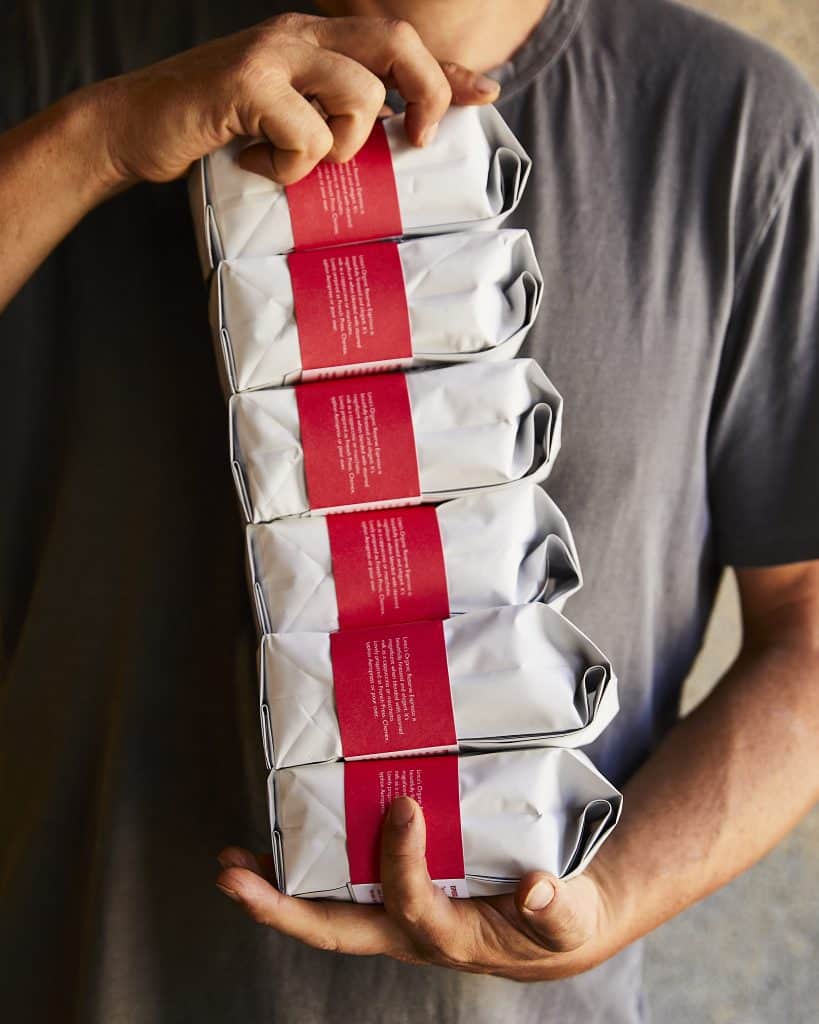 person holding stack of 6 Linea coffee bags