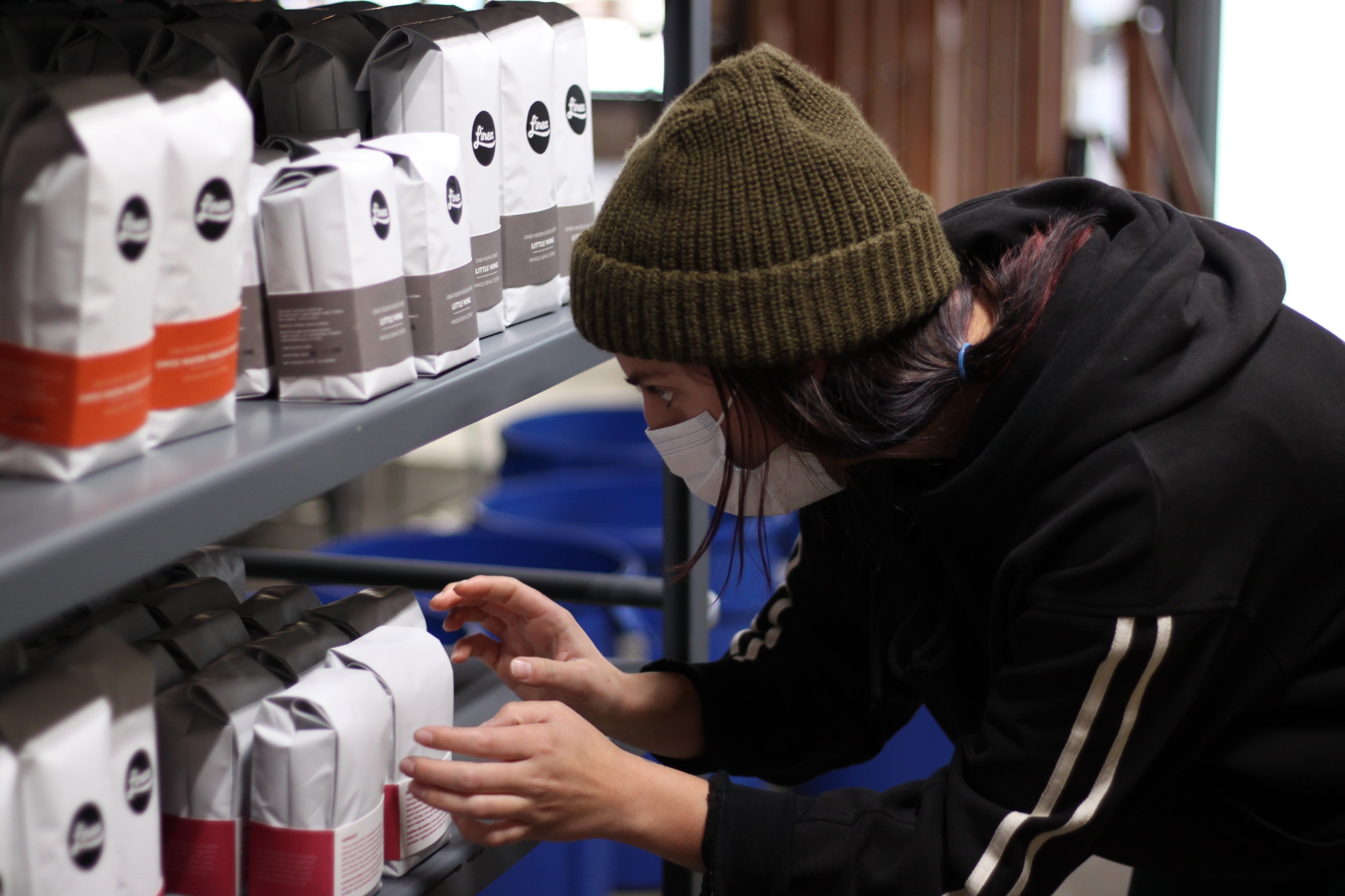 Masked Linea wholesale team member grabbing a coffee