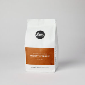Mighty Sparrow. 250 gram package of Linea Caffe's Organic Whole Bean Coffee